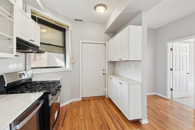 kitchen featuring white cabinetry, gas range, and tasteful backsplash