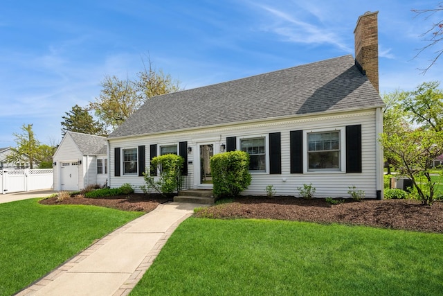 cape cod house featuring a garage, a front lawn, roof with shingles, and a chimney