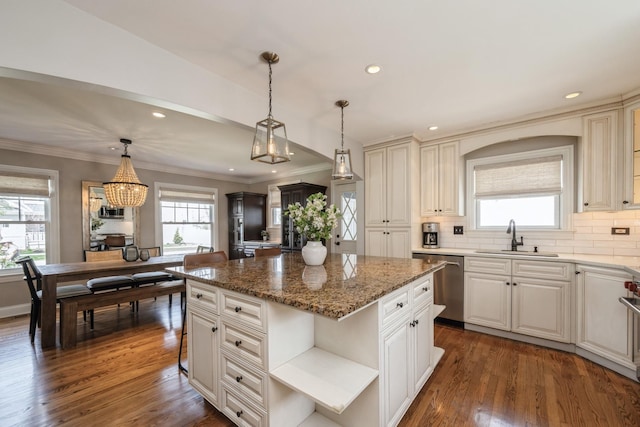 kitchen with a kitchen island, stainless steel dishwasher, open shelves, a sink, and a wealth of natural light