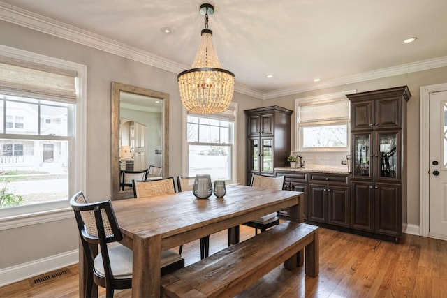dining room featuring baseboards, plenty of natural light, a notable chandelier, and visible vents