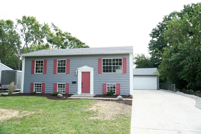 split foyer home featuring a garage and a front yard