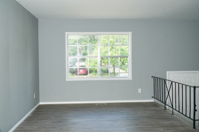 unfurnished room featuring dark hardwood / wood-style flooring