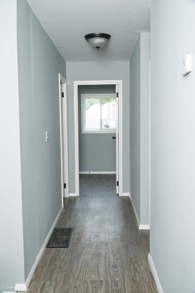 corridor featuring dark hardwood / wood-style floors