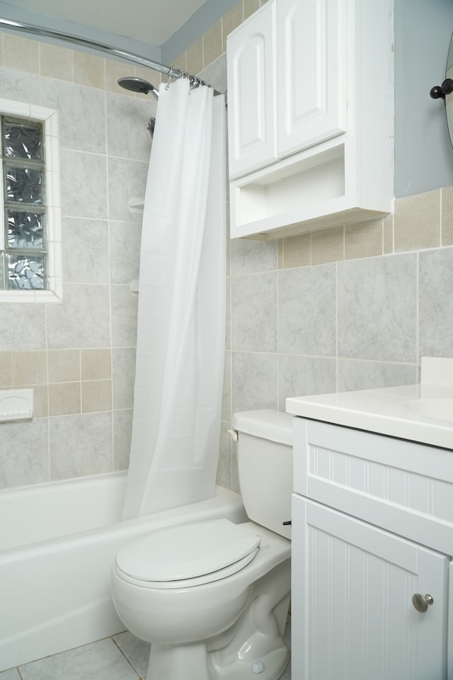 full bathroom featuring vanity, tile walls, shower / tub combo, and toilet