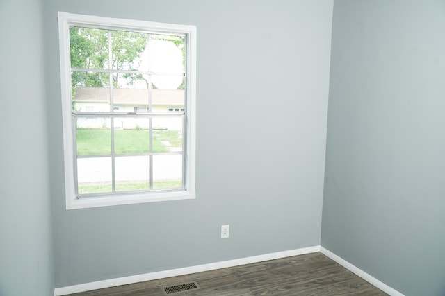 empty room with dark hardwood / wood-style flooring