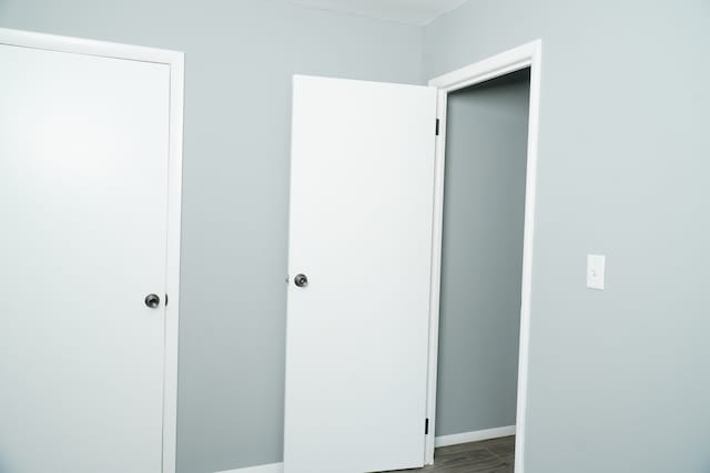 unfurnished bedroom featuring hardwood / wood-style floors and a closet