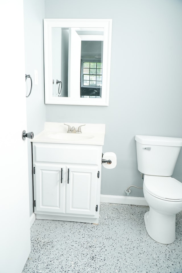 bathroom featuring toilet and vanity