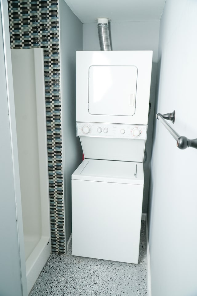 washroom with stacked washer / dryer