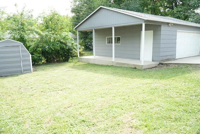 view of yard with a garage and a storage unit