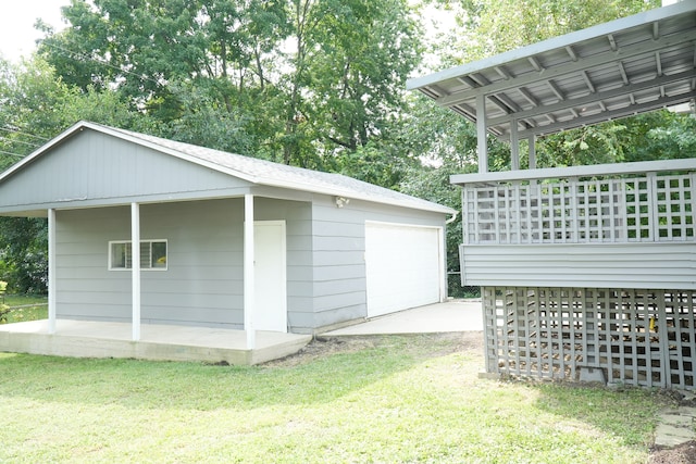 view of side of property featuring an outbuilding, a lawn, and a garage