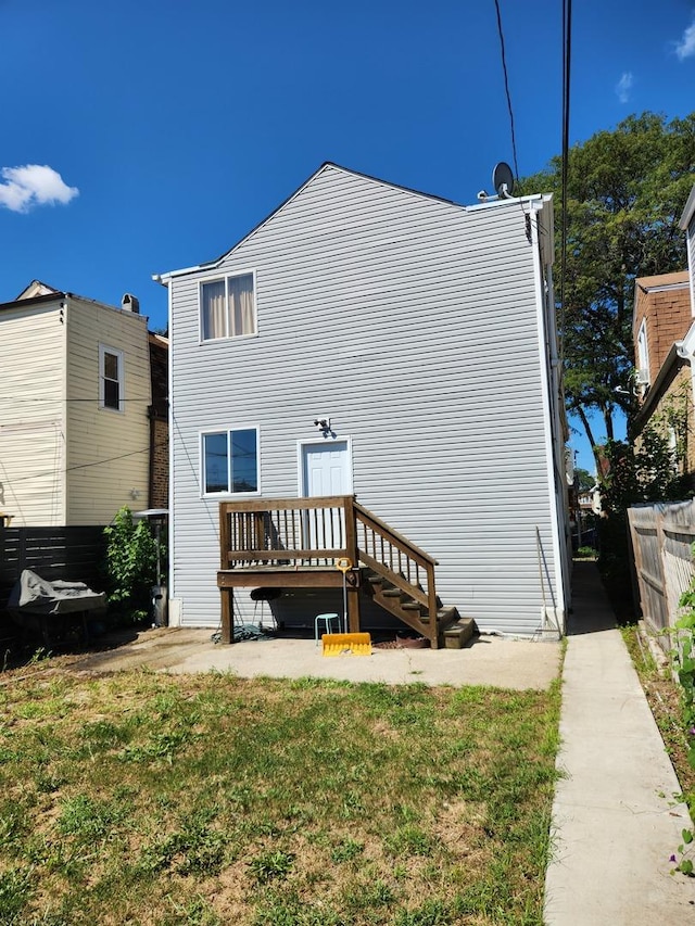 rear view of property with a lawn