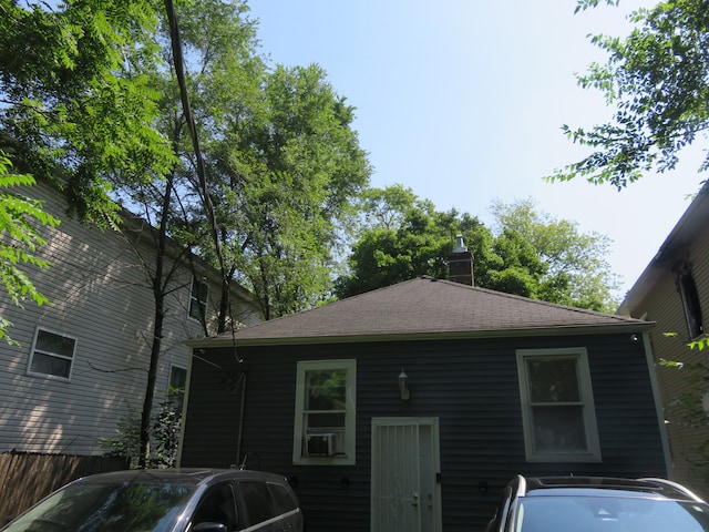 rear view of house featuring cooling unit