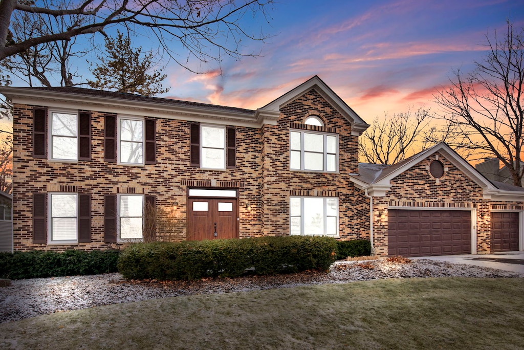 colonial inspired home featuring a yard