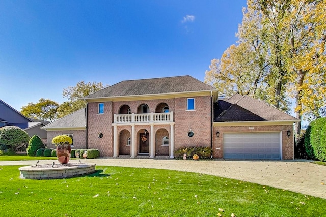 view of front of home featuring a balcony, a garage, and a front lawn