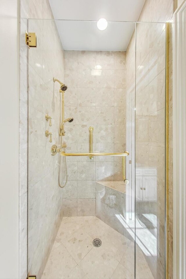 bathroom with a shower with door