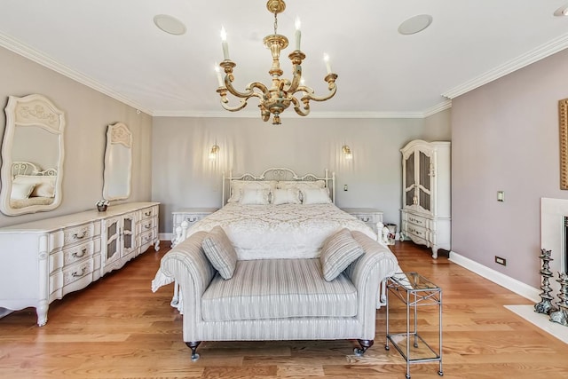 bedroom featuring light hardwood / wood-style flooring, ornamental molding, and a notable chandelier