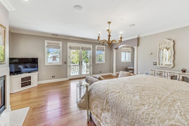 bedroom featuring access to outside, french doors, a notable chandelier, ornamental molding, and light hardwood / wood-style flooring