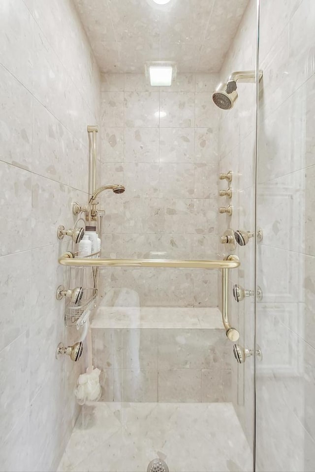 bathroom with a tile shower