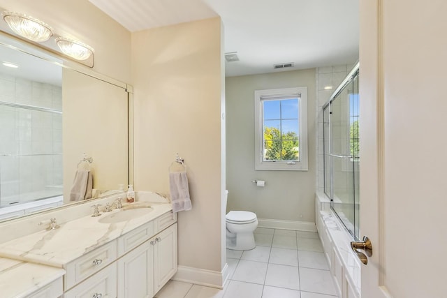 full bathroom with vanity, toilet, tile patterned floors, and enclosed tub / shower combo