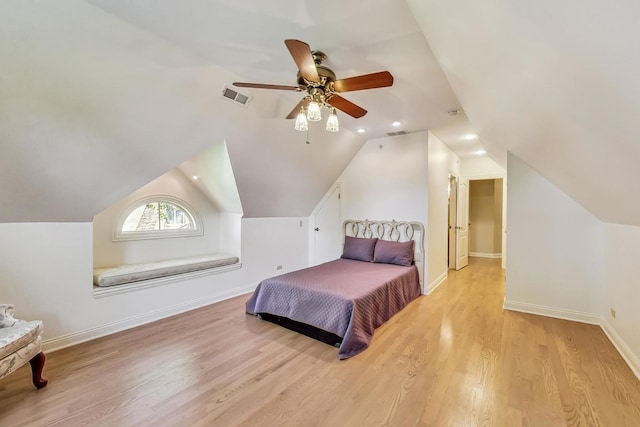 bedroom featuring vaulted ceiling, light hardwood / wood-style floors, and ceiling fan