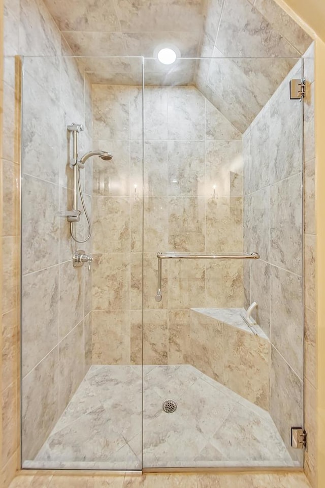 bathroom with a shower with door