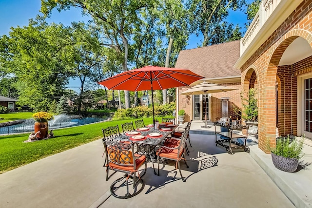 view of patio / terrace featuring french doors and a water view