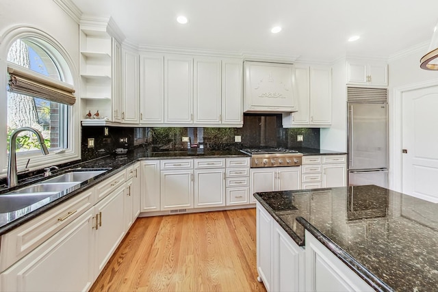 kitchen featuring sink, appliances with stainless steel finishes, white cabinetry, and tasteful backsplash