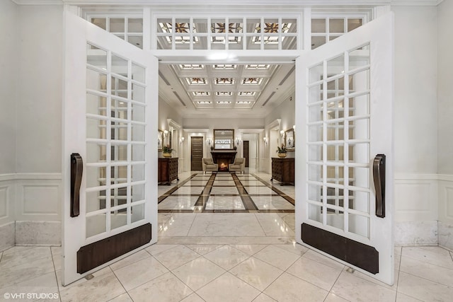 hall with crown molding, tile patterned flooring, and french doors