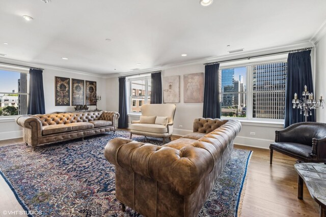 living room with light hardwood / wood-style floors and ornamental molding