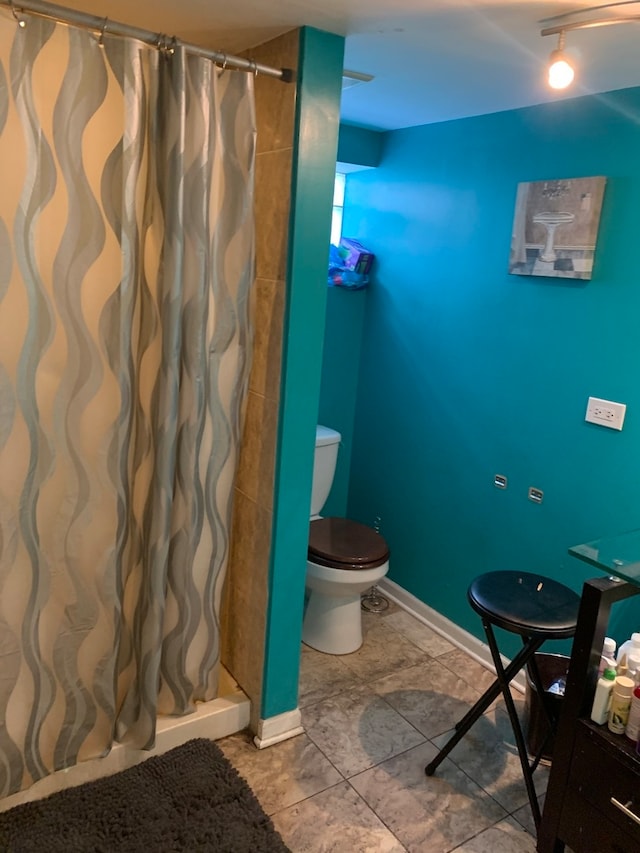 bathroom with tile patterned floors and toilet