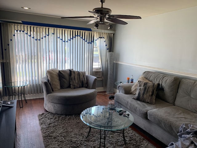 living room featuring ceiling fan, dark hardwood / wood-style floors, and a healthy amount of sunlight