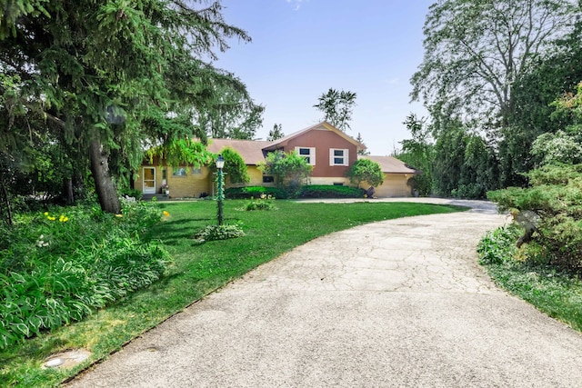 view of front of house with a front yard and a garage