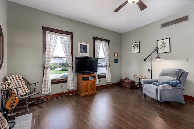 sitting room featuring ceiling fan, plenty of natural light, and dark hardwood / wood-style floors