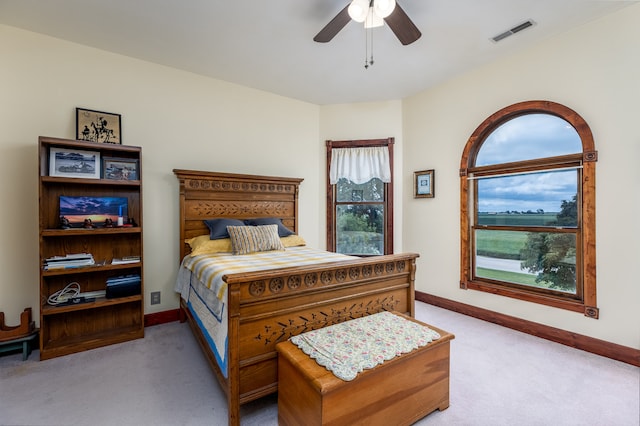 bedroom with light colored carpet and ceiling fan