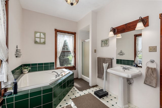 bathroom featuring plus walk in shower and tile patterned floors