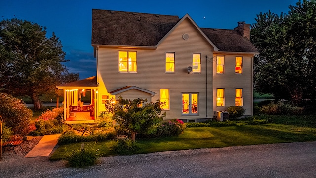 view of front facade with a front yard and central AC unit