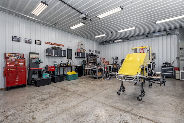 garage with a garage door opener and a workshop area