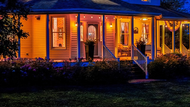 view of front of property with covered porch and a front yard