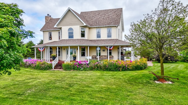 view of front facade with a front lawn and covered porch