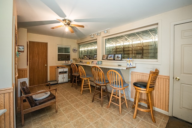 bar with ceiling fan and light tile patterned flooring