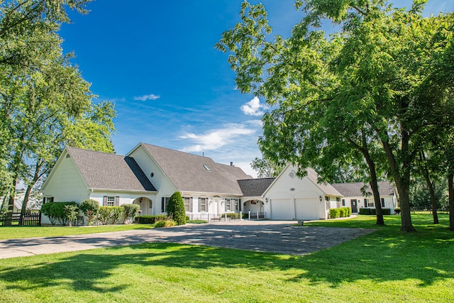 view of front of property featuring a garage and a front yard