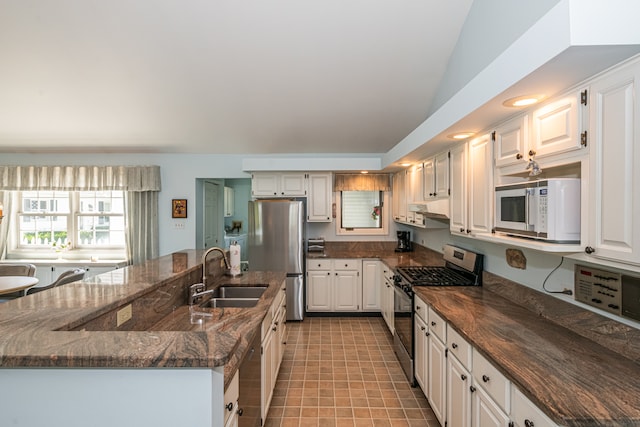 kitchen with sink, white cabinetry, light tile patterned flooring, and stainless steel appliances