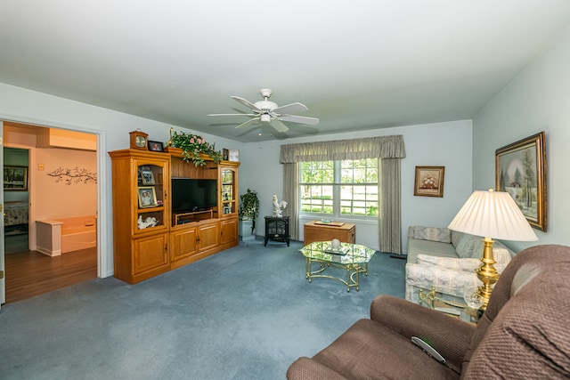 living room with hardwood / wood-style flooring and ceiling fan