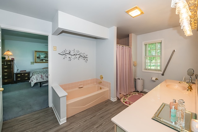 bathroom featuring a bath, vanity, and hardwood / wood-style floors