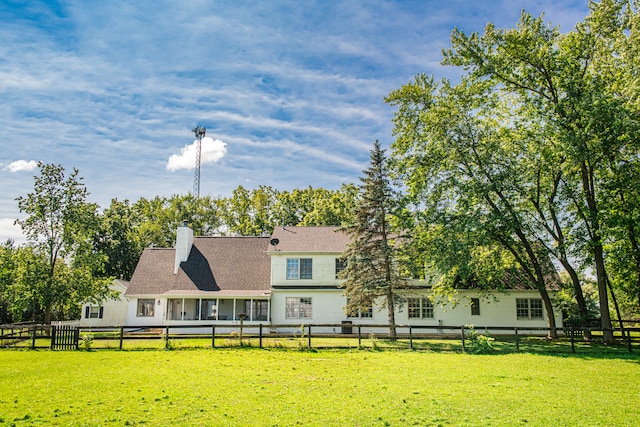 back of house with a lawn