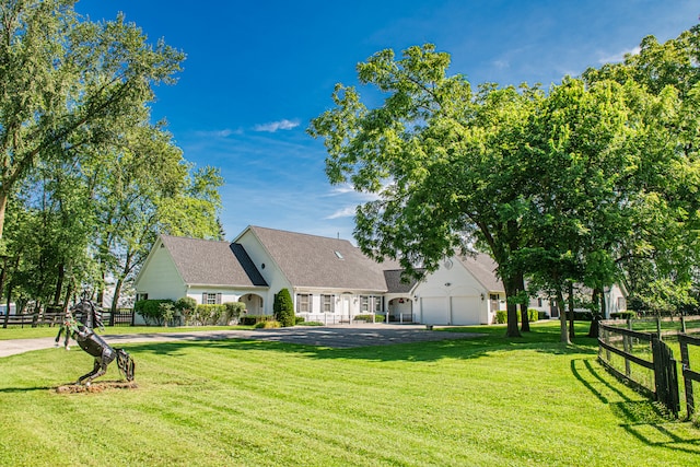 view of front of house with a front lawn and a garage