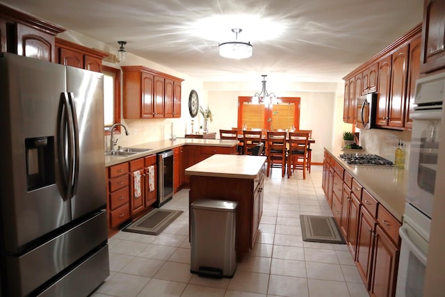 kitchen with stainless steel appliances, a center island, sink, tasteful backsplash, and pendant lighting