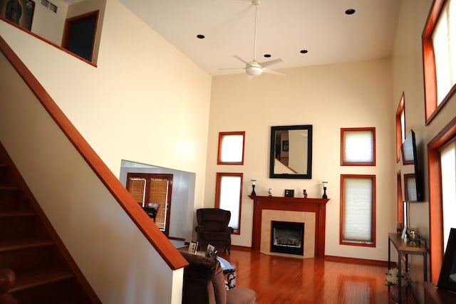 living room with high vaulted ceiling and hardwood / wood-style floors