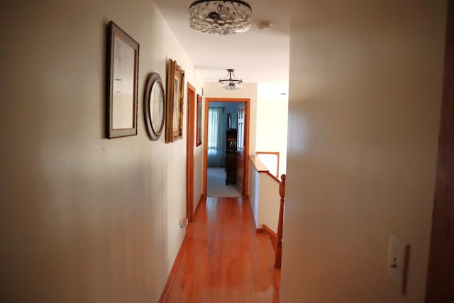 hallway with light hardwood / wood-style flooring