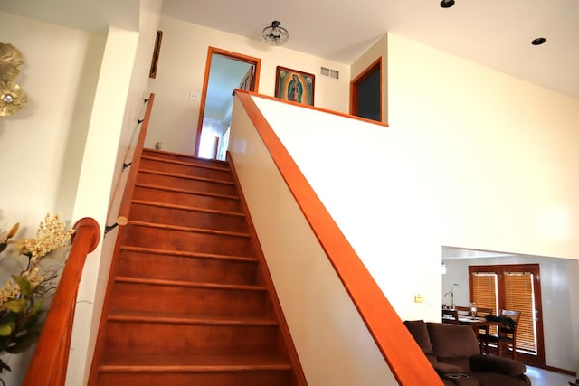 stairs featuring a high ceiling